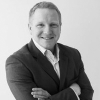 Brian Ray headshot, smiling, arms folded across chest